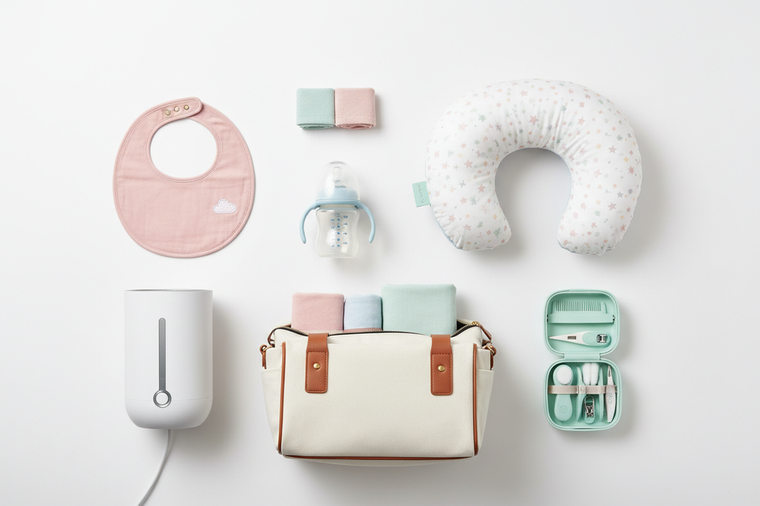 Flat lay of newborn baby essentials including feeding bottle, bibs, bottle warmer, nursing pillow, diaper bag, and grooming kit on white background